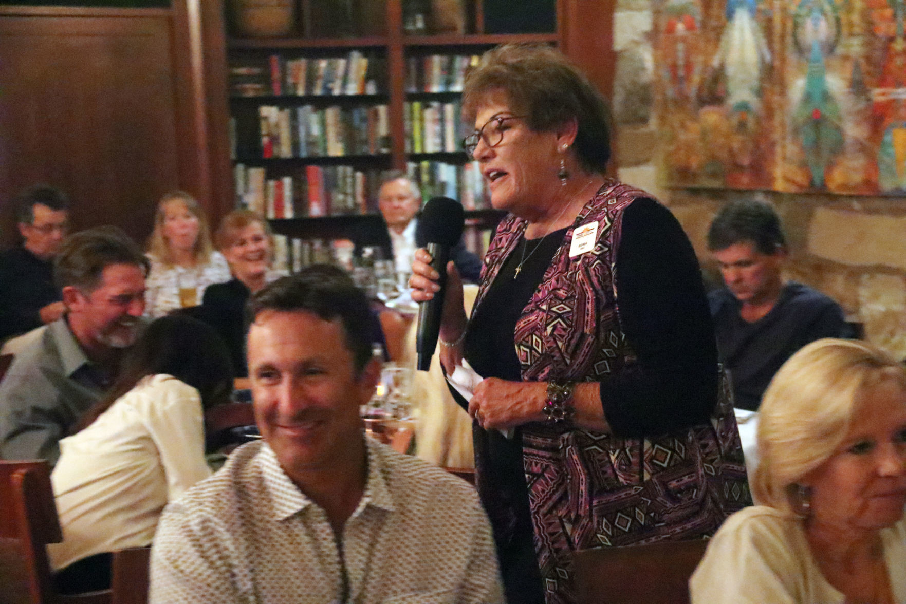 Edna Welsheimer as auctioneer at Time Out fundraiser